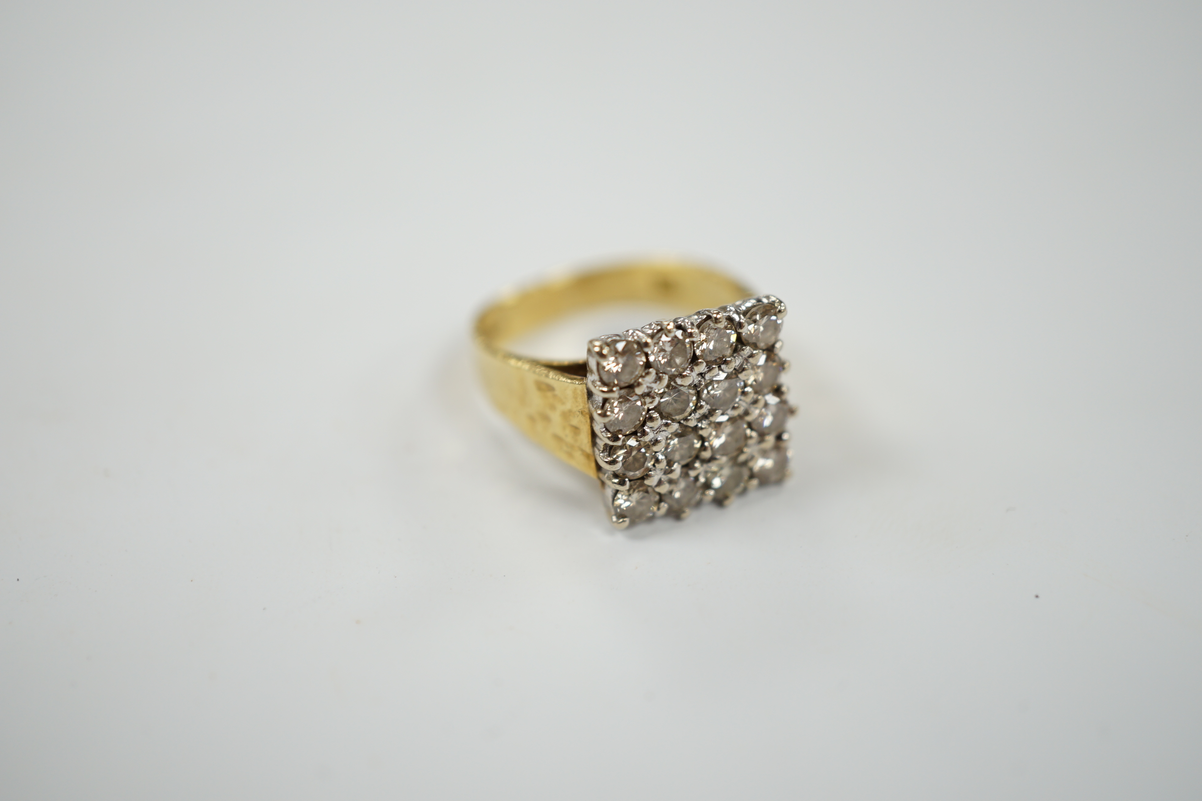 A modern textured 18ct gold and diamond cluster set tablet ring, size K/L, gross weight 6.8 grams.